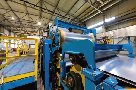 Stainless steel coil processing line in AKS factory, showing advanced manufacturing equipment and bright annealing preparation.