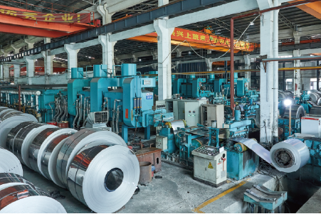 Close-up of stainless steel flattening machine, part of the precision line feeding into annealing furnace system.