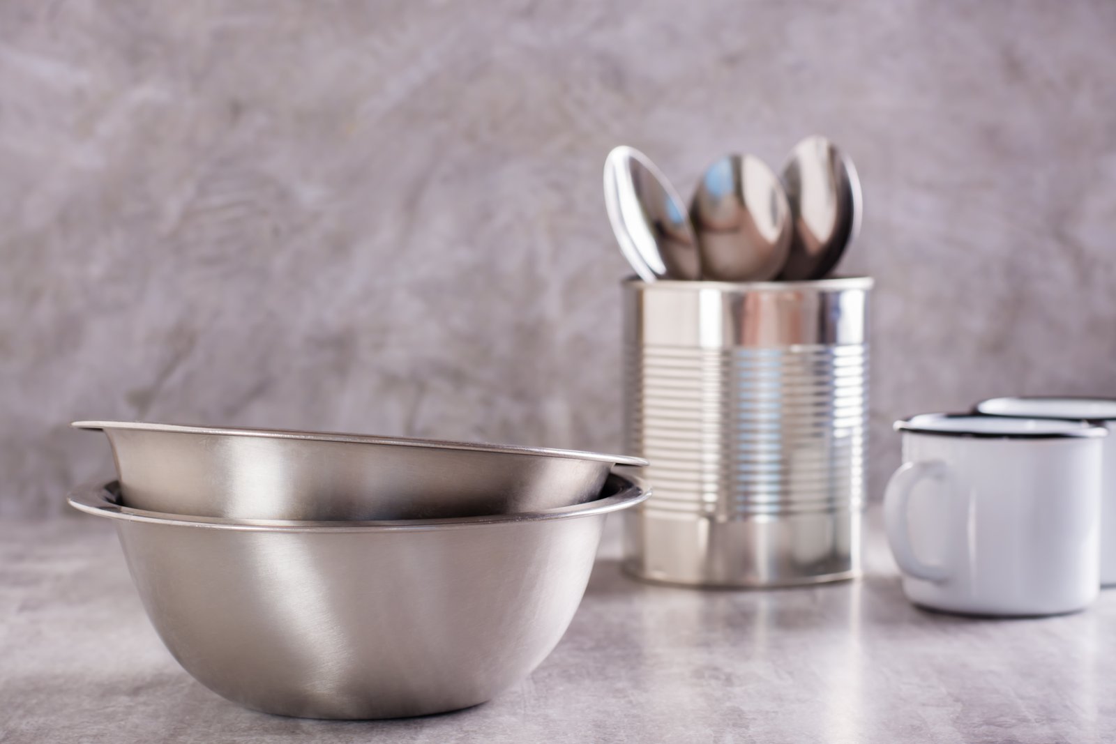 Top view of stainless steel cookware and kitchen tools made from heat-treated coils, highlighting uniform thickness and high strength.