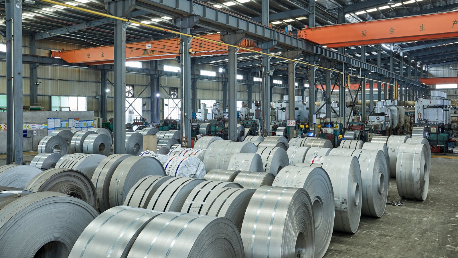 Stainless steel coil storage area with visible annealing line numbers