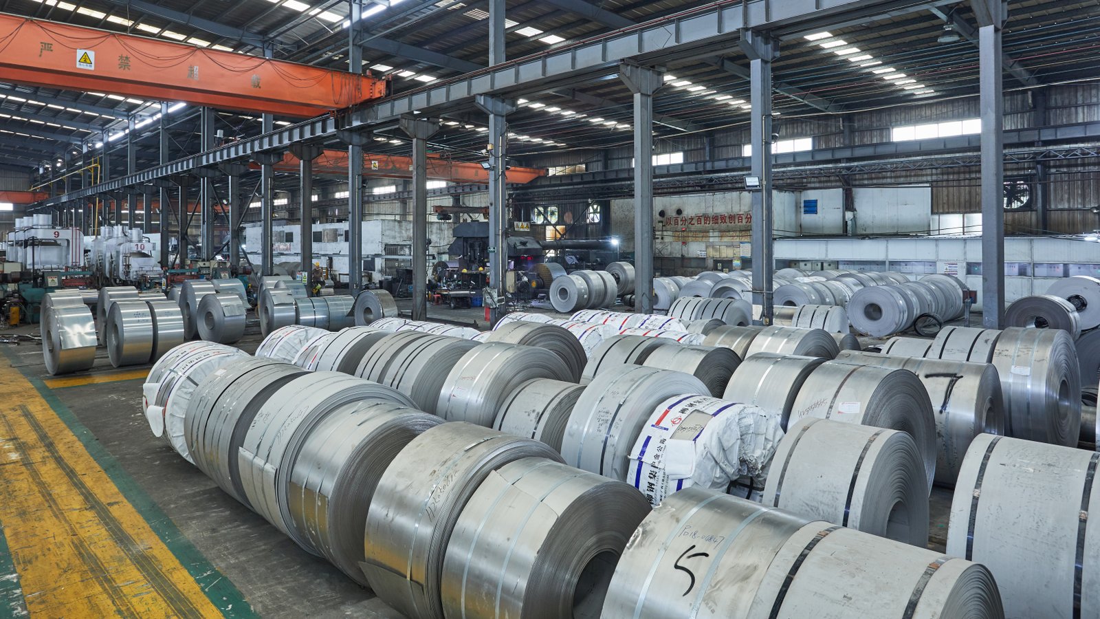 Factory storage area filled with stainless steel coils awaiting treatment