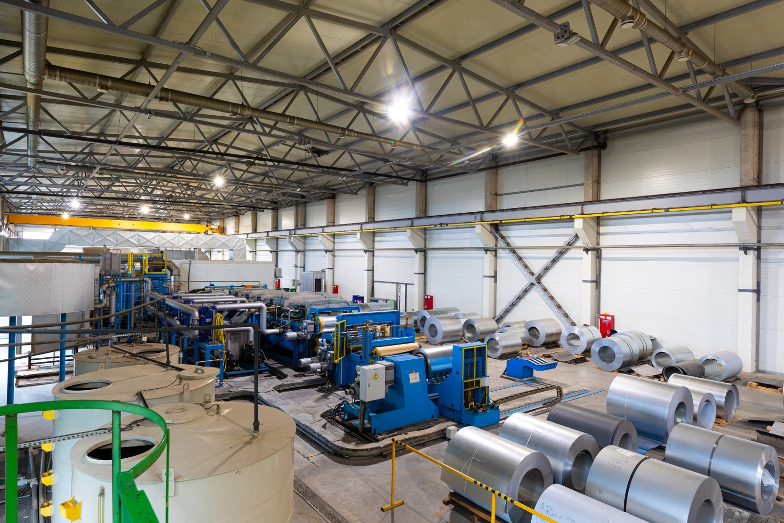 Bird’s-eye view of AKS smart workshop with advanced green-painted sheet handling equipment and optimized layout.