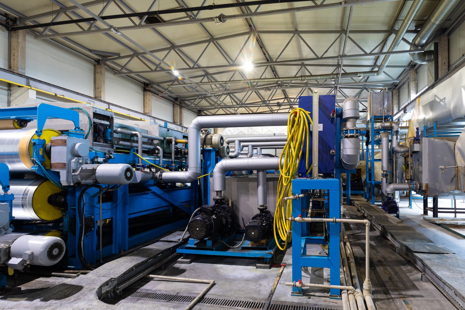 Coil flattening and feeding system with digital control panel, ready for entry into annealing furnace zone.