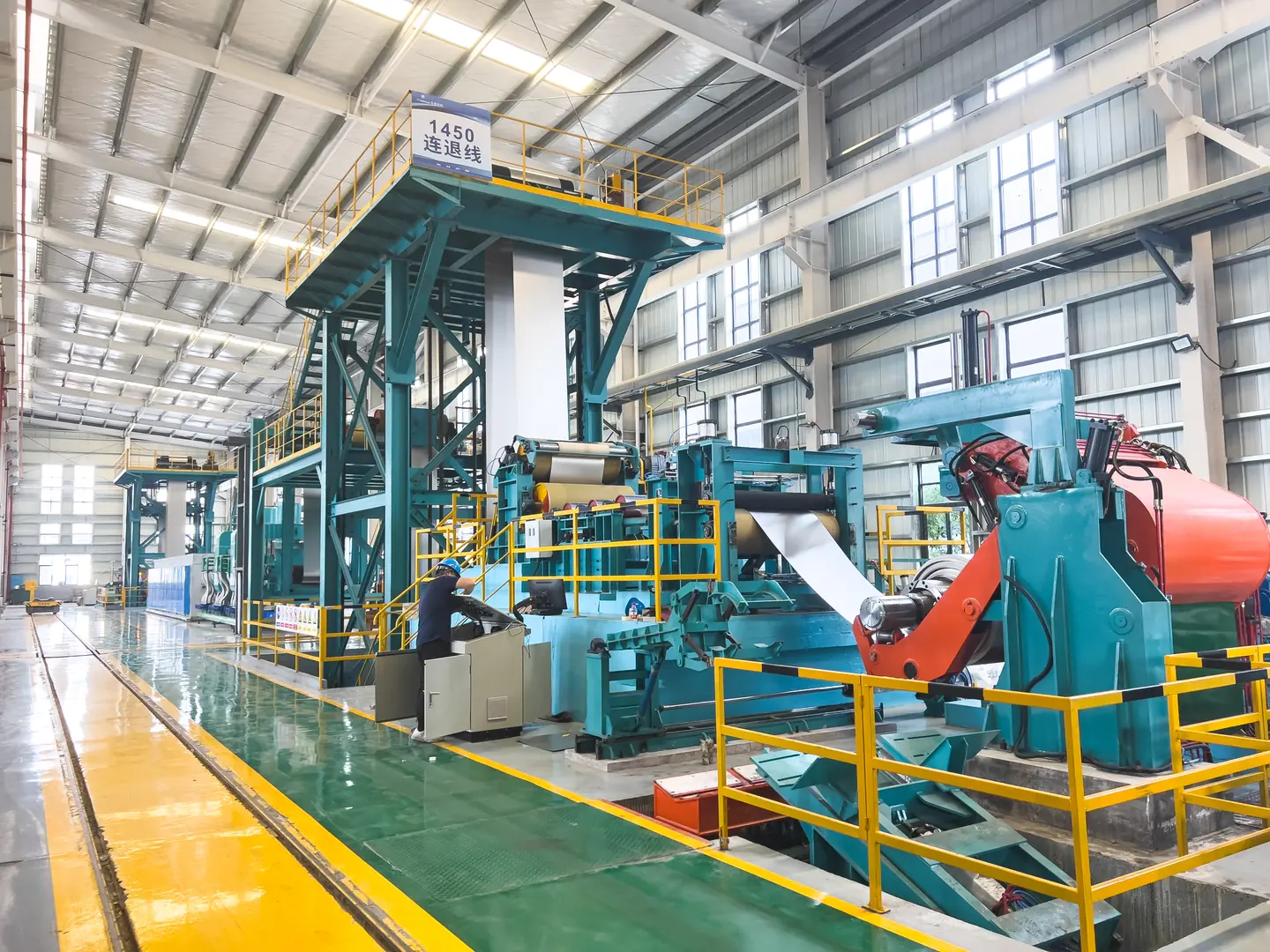 Modern industrial annealing furnace with advanced control systems and energy-efficient design, featuring a worker operatin...