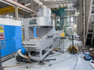 Technician working on large industrial furnace in modern factory