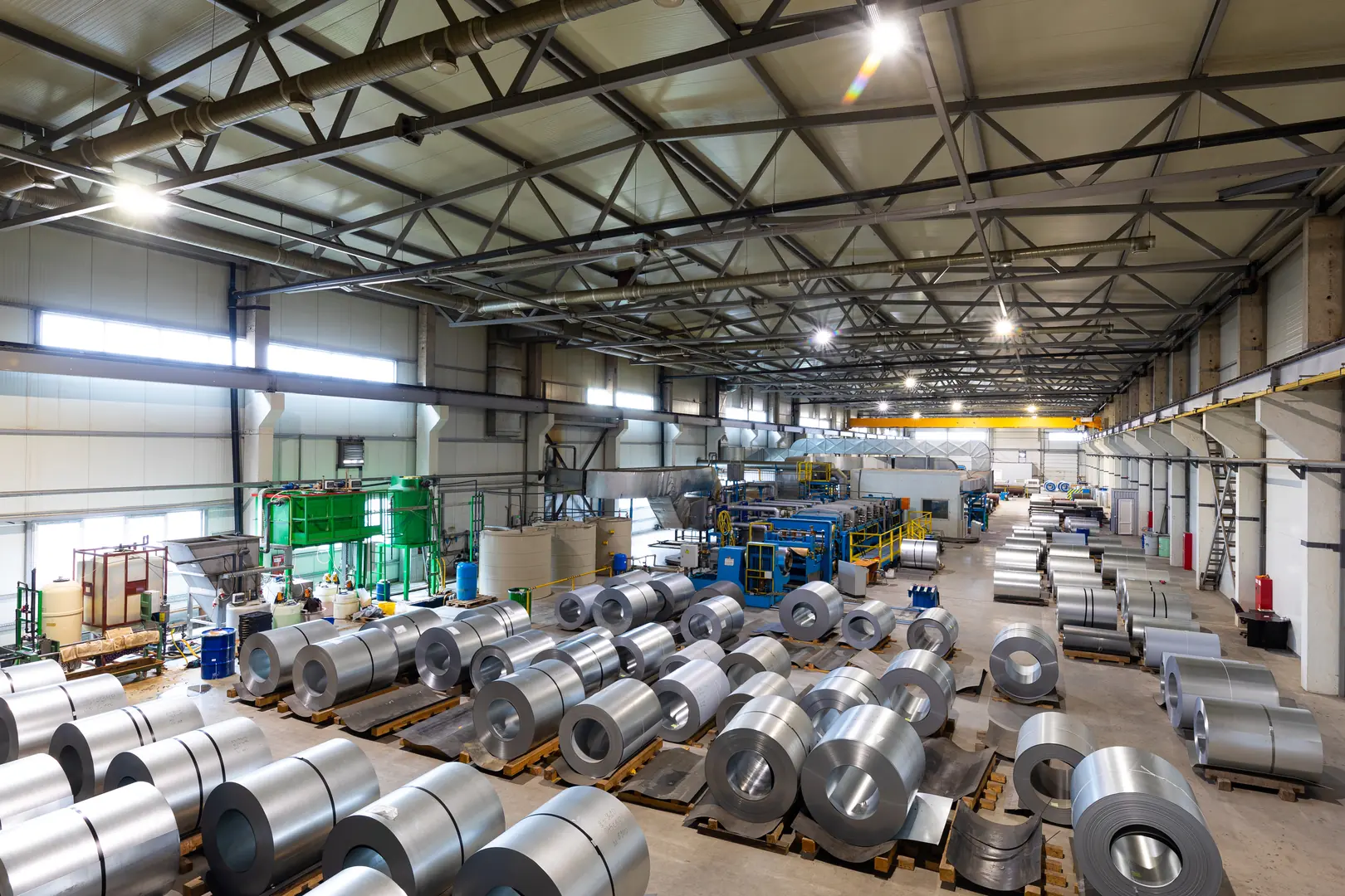 Interior of a high-tech industrial furnace facility with metal coils and advanced machinery.