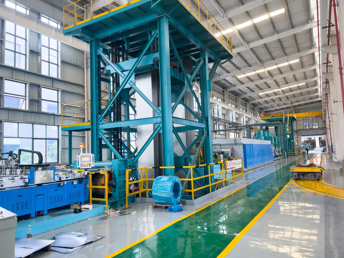 Interior view of an industrial facility with advanced heat treatment equipment and machinery