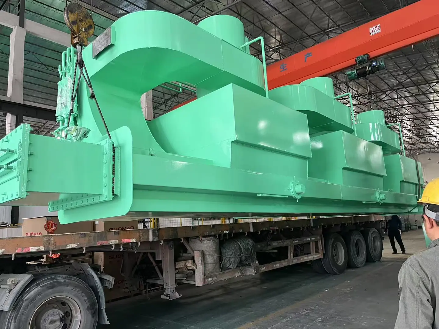 Large green bright annealing furnace on a truck in a factory setting